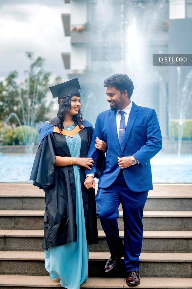 A graduate and her partner sharing a graduation portrait